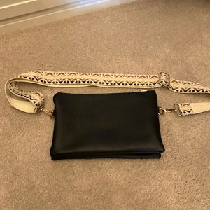 Crossbody bag with guitar strap and wristlet.